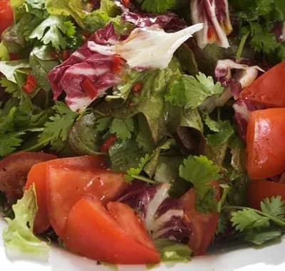 A mixed garden salad with tomato and radicchio